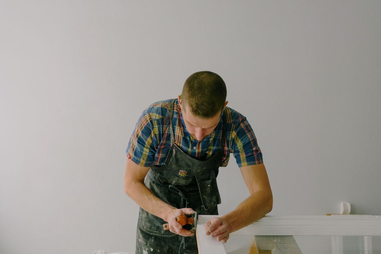 Joiner working a wooden plank to size